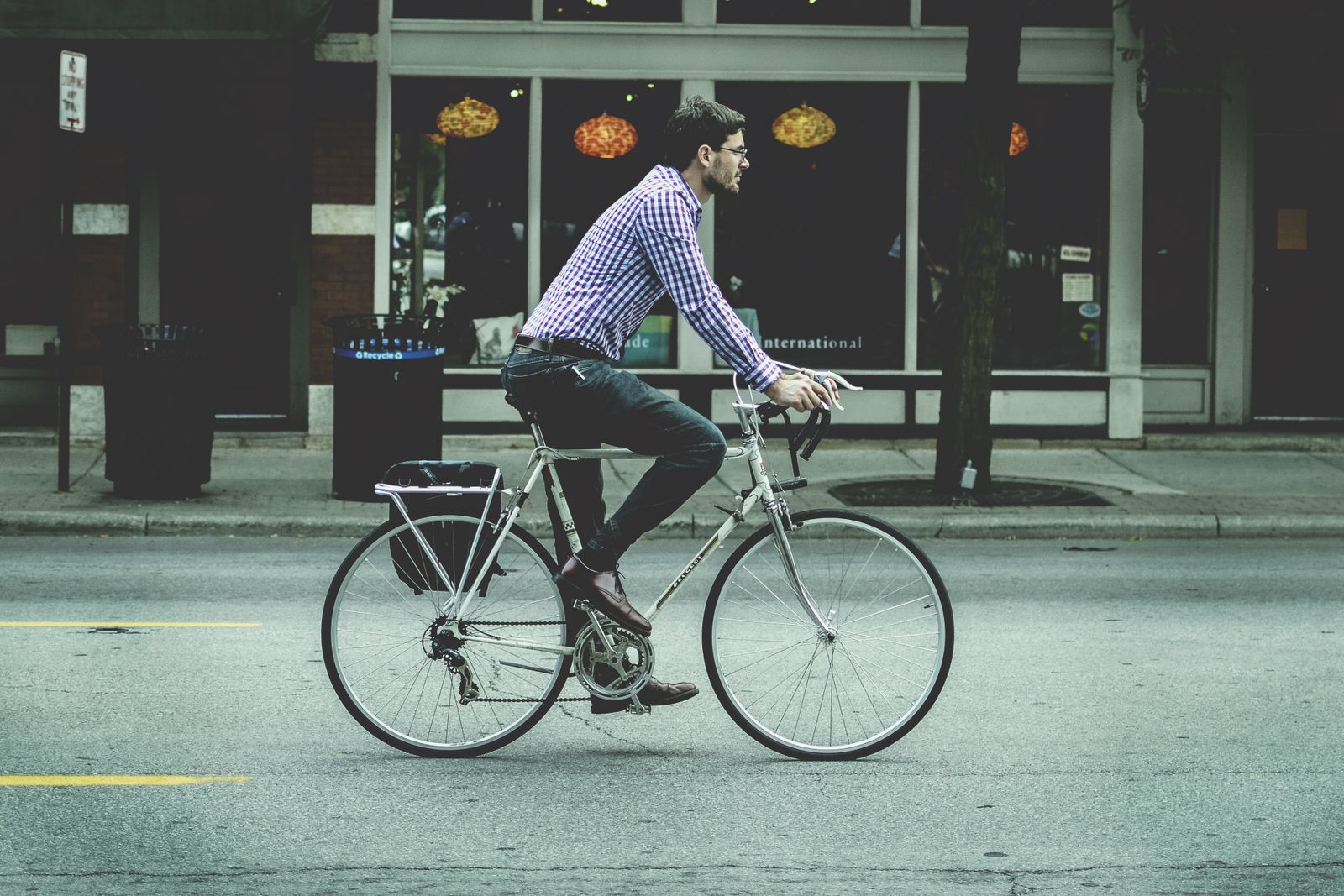 A person cycling to work through a city street in the morning.