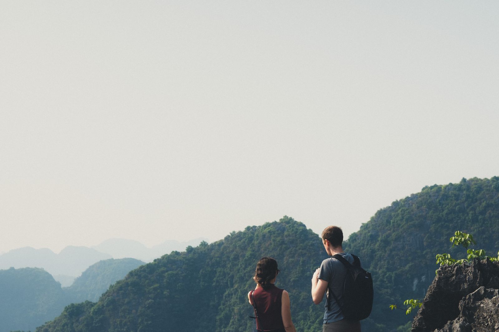 An active older couple hiking together at a scenic mountain viewpoint.
