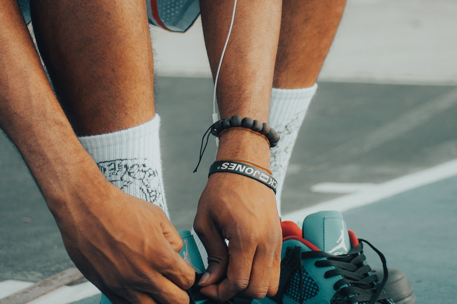 A close-up of a person lacing up their running shoes before a run.