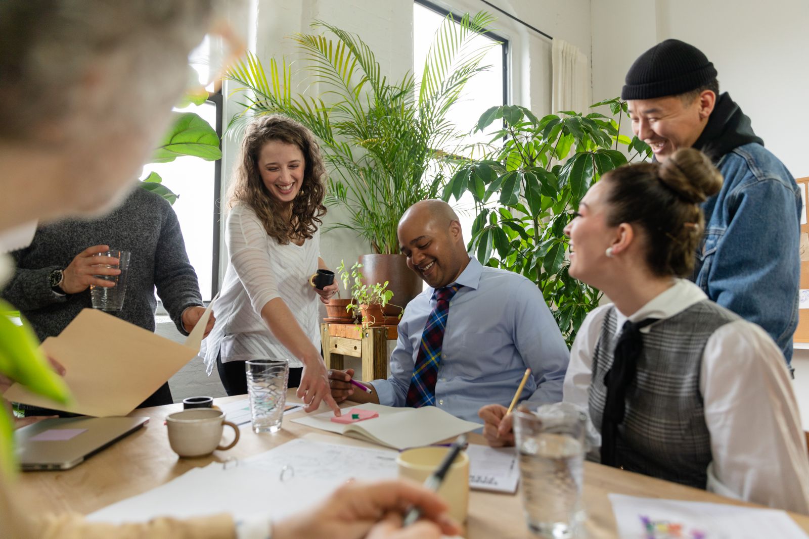 A diverse team of colleagues smiling together in a bright office.